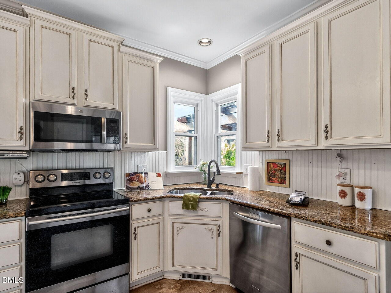 4500 Rivershyre Way Raleigh, NC 27616 - Photo 14 of 42 a kitchen with granite countertop white cabinets and stainless steel appliances