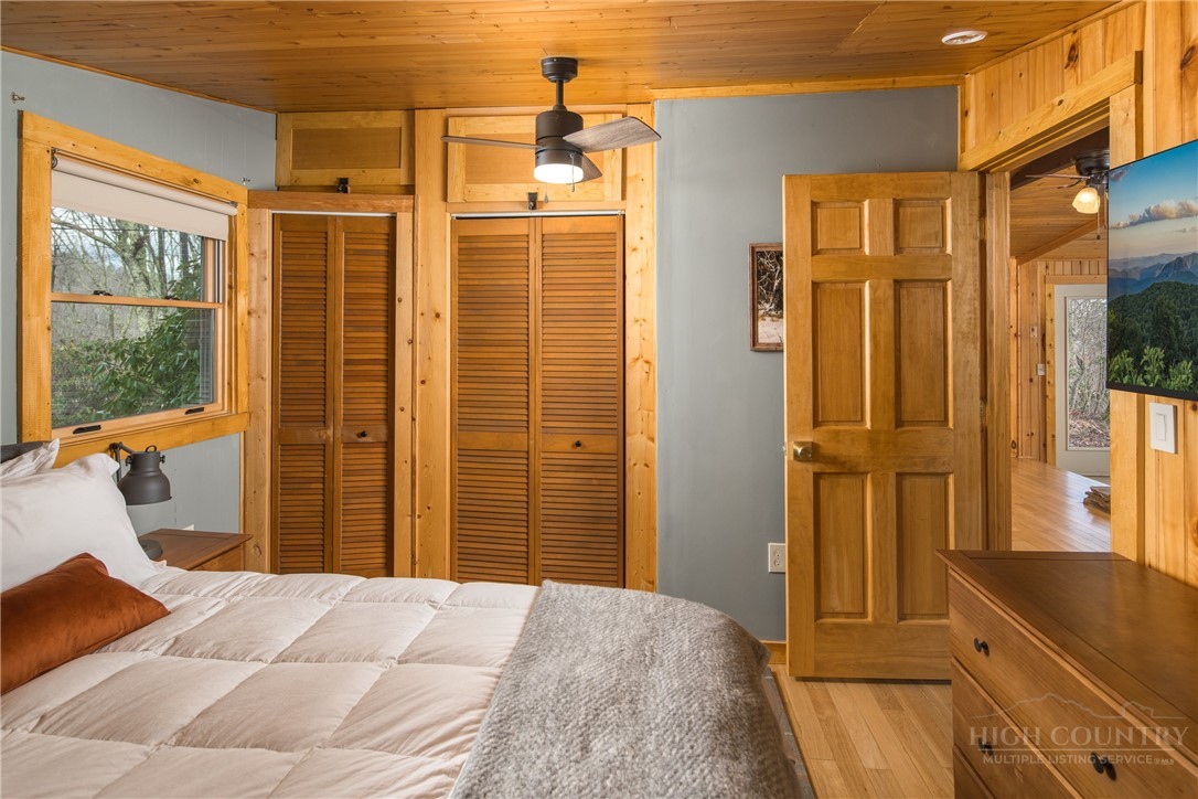280 Chinkapin Ridge Road Seven Devils, NC 28604 - Photo 16 of 40 a bedroom with a bed and wooden floor