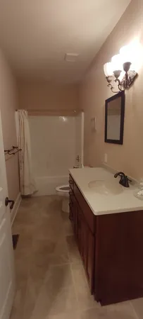 a room with a large bed and cabinets