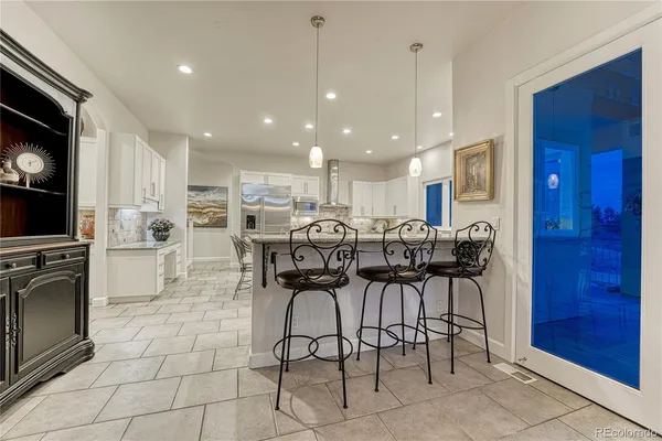 a kitchen with white cabinets a sink and white appliances