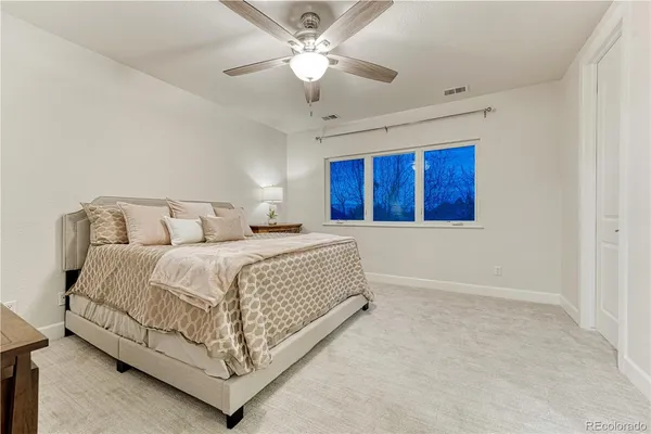 a bedroom with a bed and a table in it