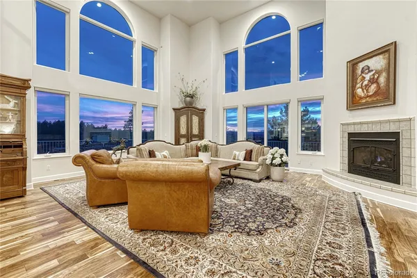 a living room with fireplace furniture and a rug