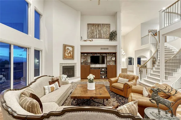 a living room with furniture fireplace and a large window