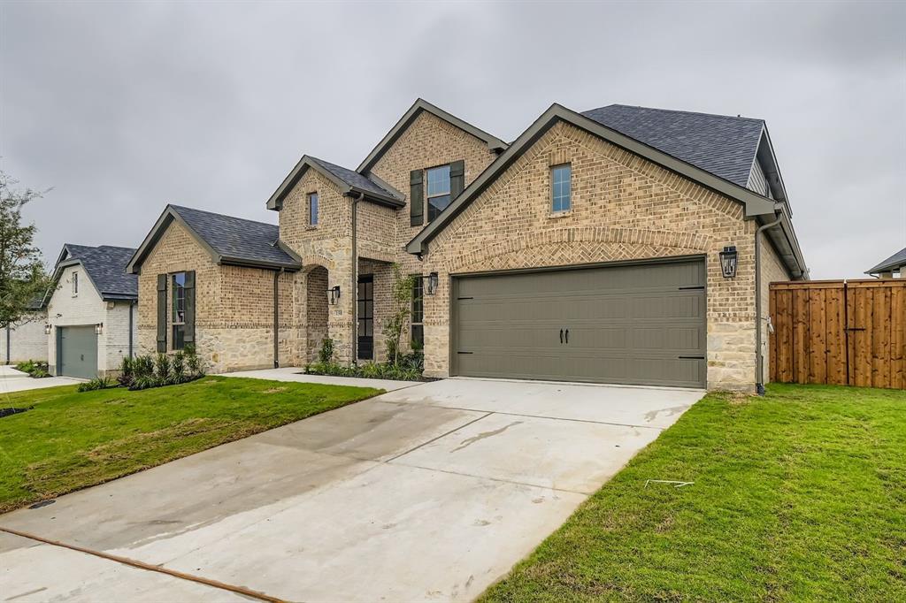 150 Longhorn Bend Rhome, TX 76078 - Photo 2 of 28 View of front of house featuring brick siding, concrete driveway, and a shingled roof