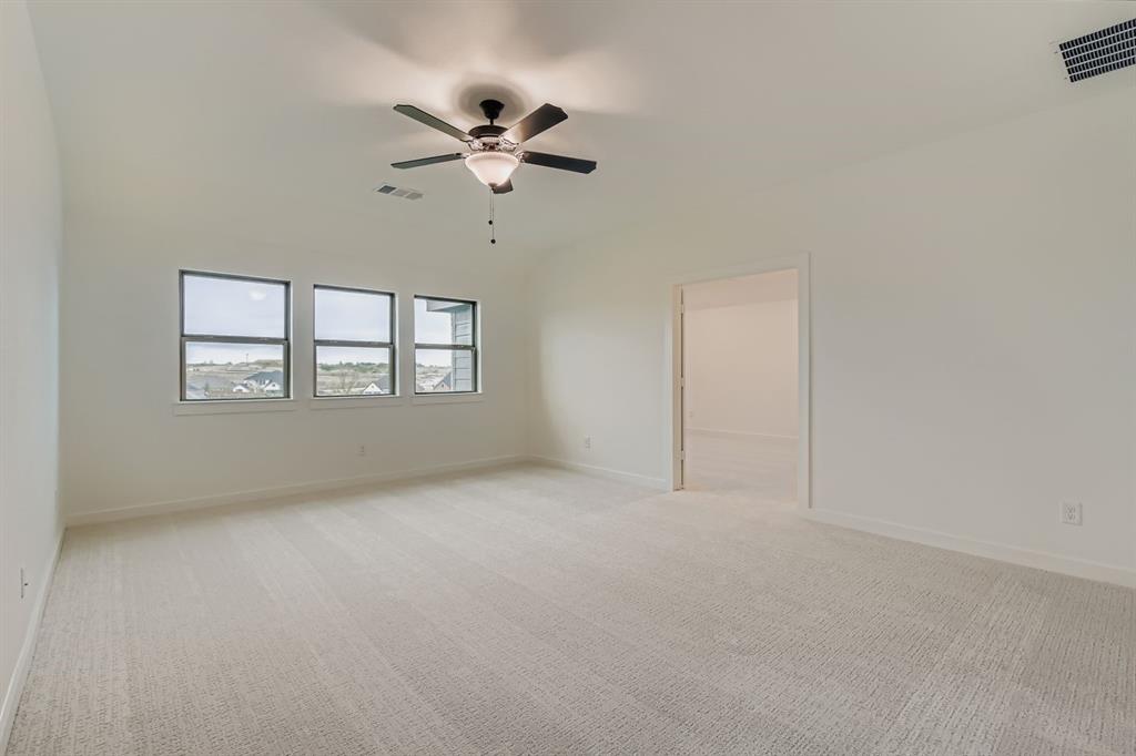 150 Longhorn Bend Rhome, TX 76078 - Photo 22 of 28 Unfurnished room with light colored carpet and a ceiling fan