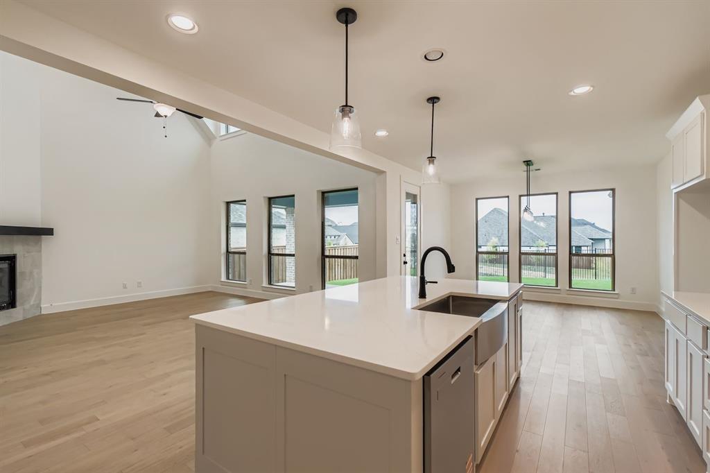150 Longhorn Bend Rhome, TX 76078 - Photo 28 of 28 Kitchen with open floor plan, recessed lighting, hanging light fixtures, light wood-type flooring, and white cabinets
