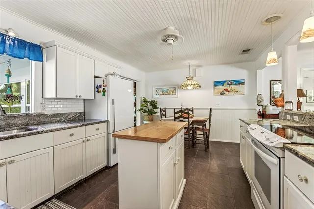 a bedroom with a bed a dresser and a window