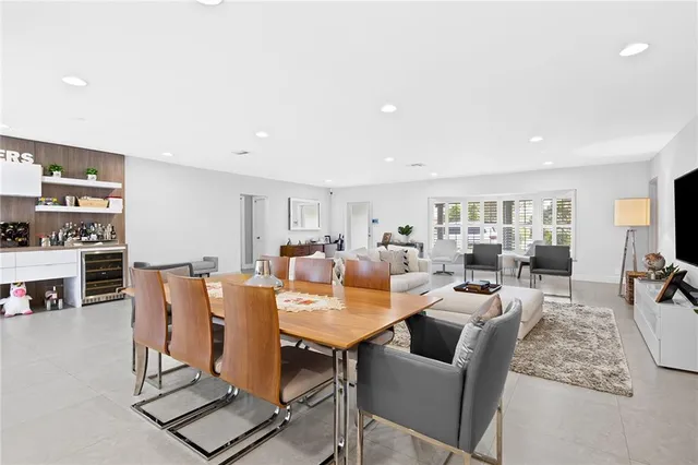 a living room with furniture a rug and a kitchen view