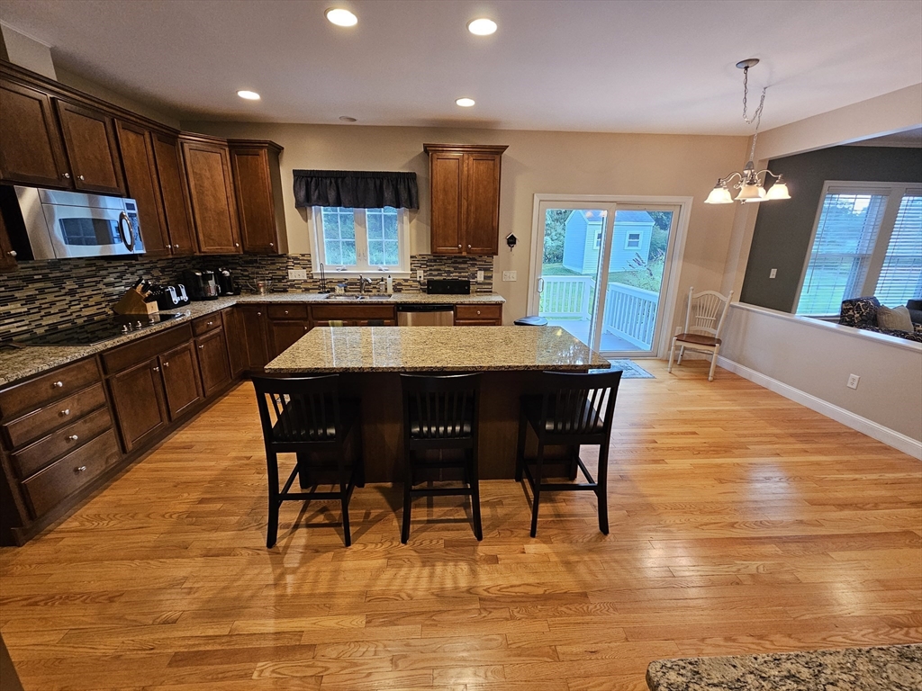 11 Bunting Way Danvers, MA 01923 - Photo 5 of 42 a large kitchen with a table and chairs in it