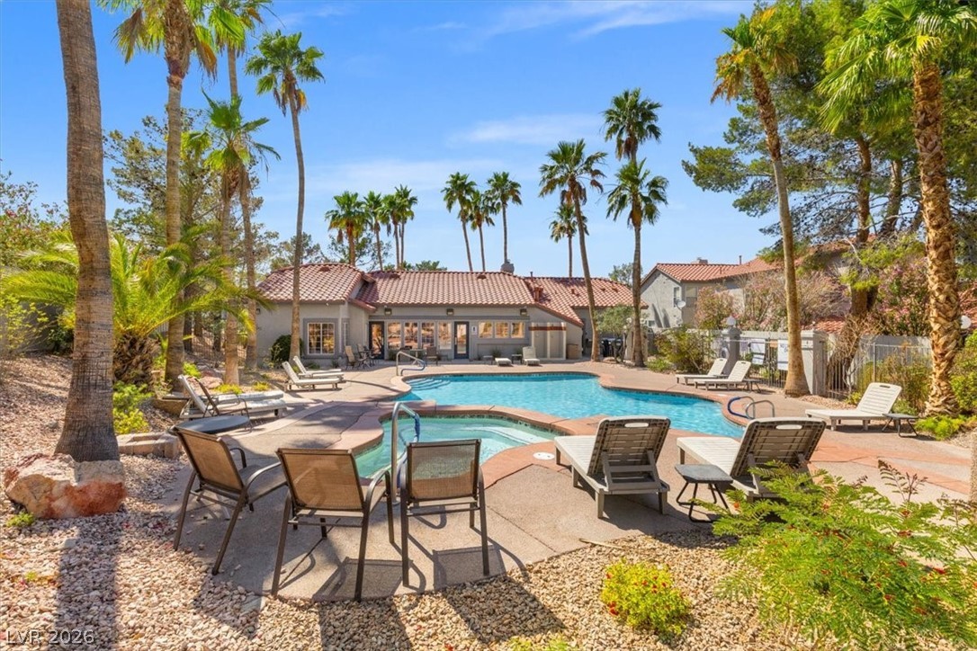 2377 Ramsgate Drive Henderson, NV 89074 - Photo 2 of 25 A refreshing pool area with sun loungers beckons under tall palm trees.