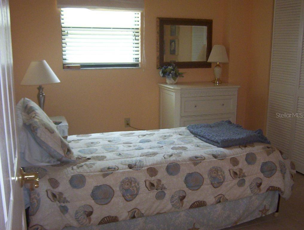 13650 Gulf Boulevard, Unit 304 Madeira Beach, FL 33708 - Photo 55 of 63 a bedroom with a bed and a window