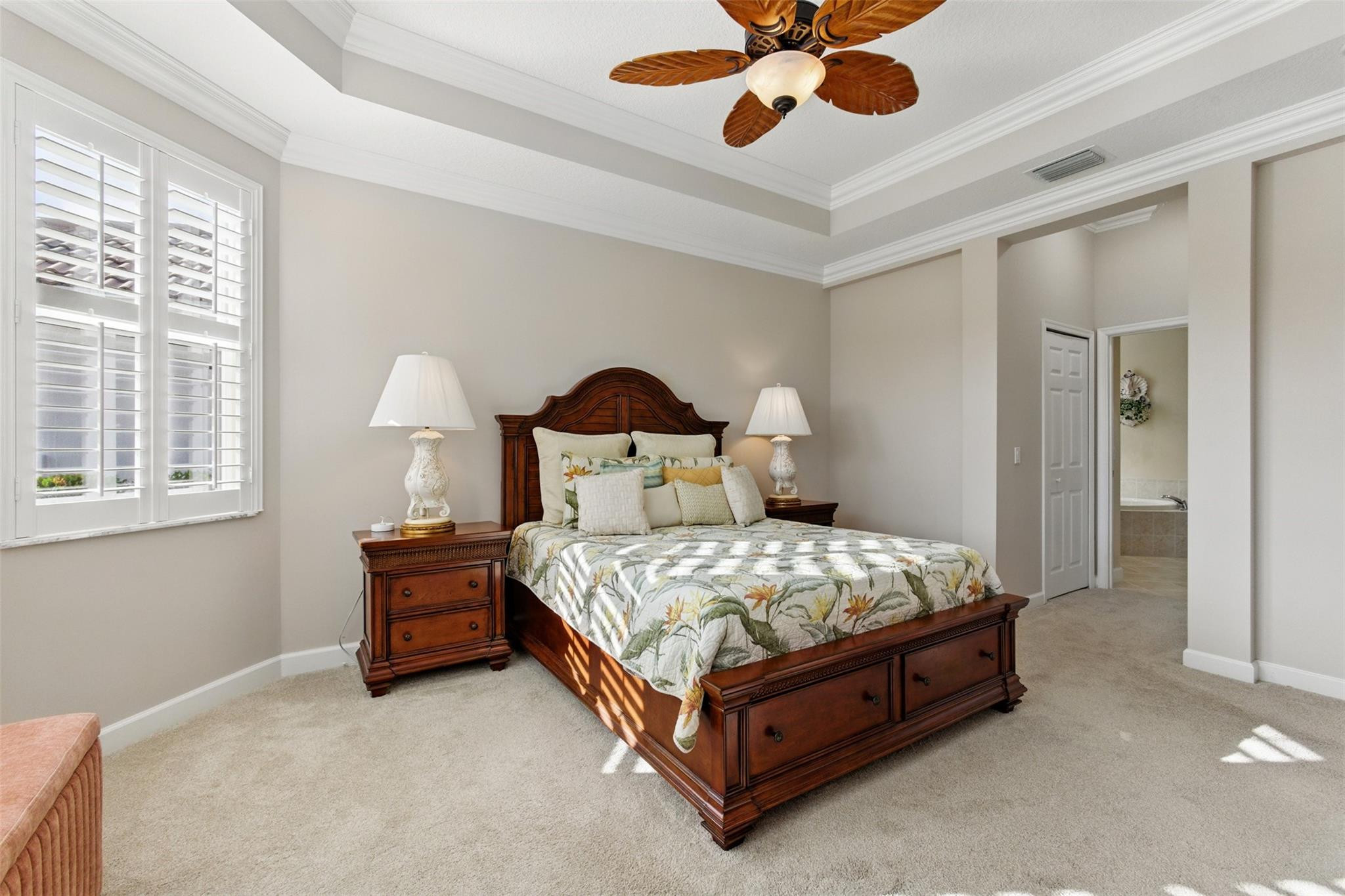 8836 First Tee Road Port St. Lucie, FL 34986 - Photo 14 of 35 a bedroom with a bed and a chandelier