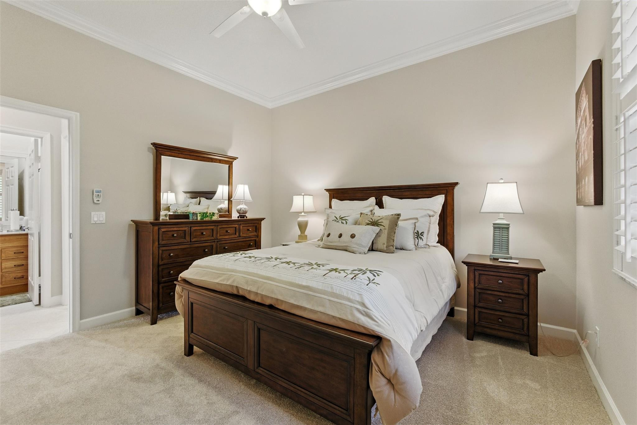 8836 First Tee Road Port St. Lucie, FL 34986 - Photo 16 of 35 a bedroom with a bed and a flat tv screen on dresser