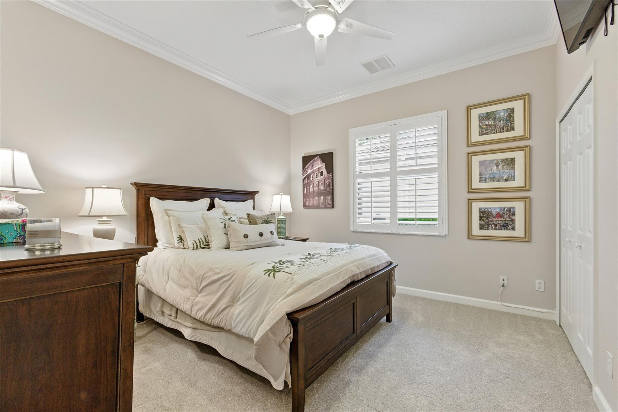 8836 First Tee Road Port St. Lucie, FL 34986 - Photo 17 of 35 a bedroom with a bed and a window