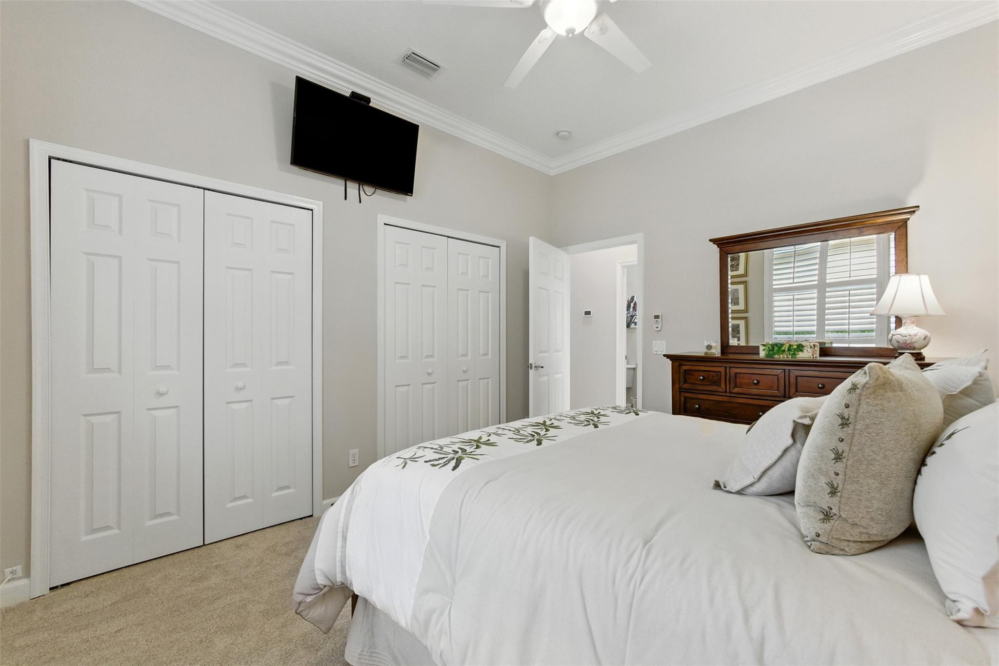 8836 First Tee Road Port St. Lucie, FL 34986 - Photo 18 of 35 a bedroom with a bed and a television