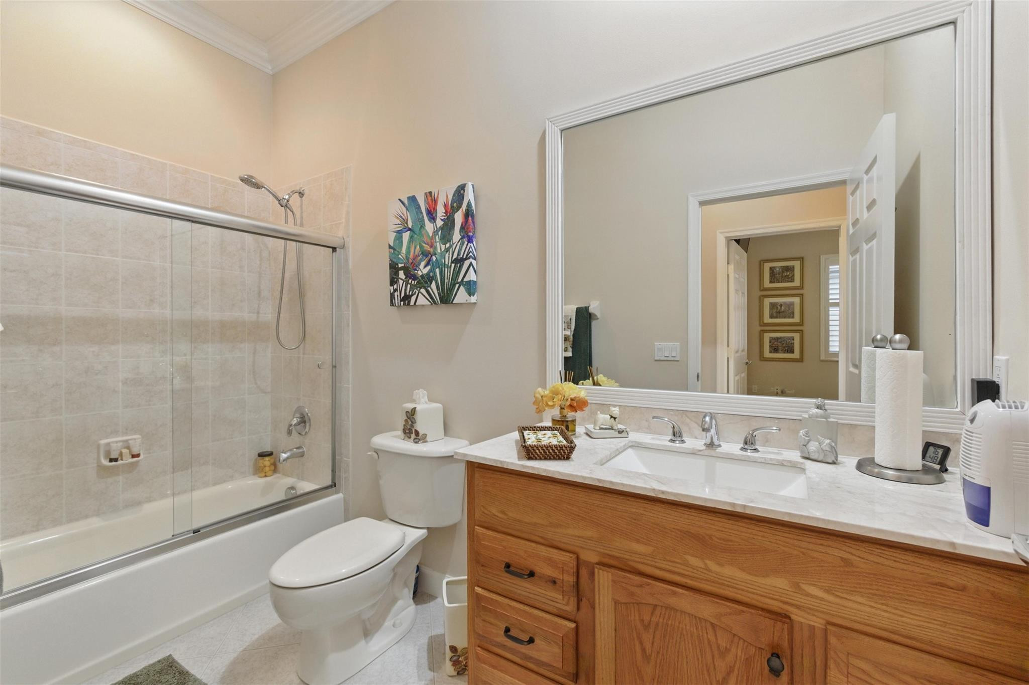 8836 First Tee Road Port St. Lucie, FL 34986 - Photo 19 of 35 a bathroom with a granite countertop sink a toilet and a bathtub