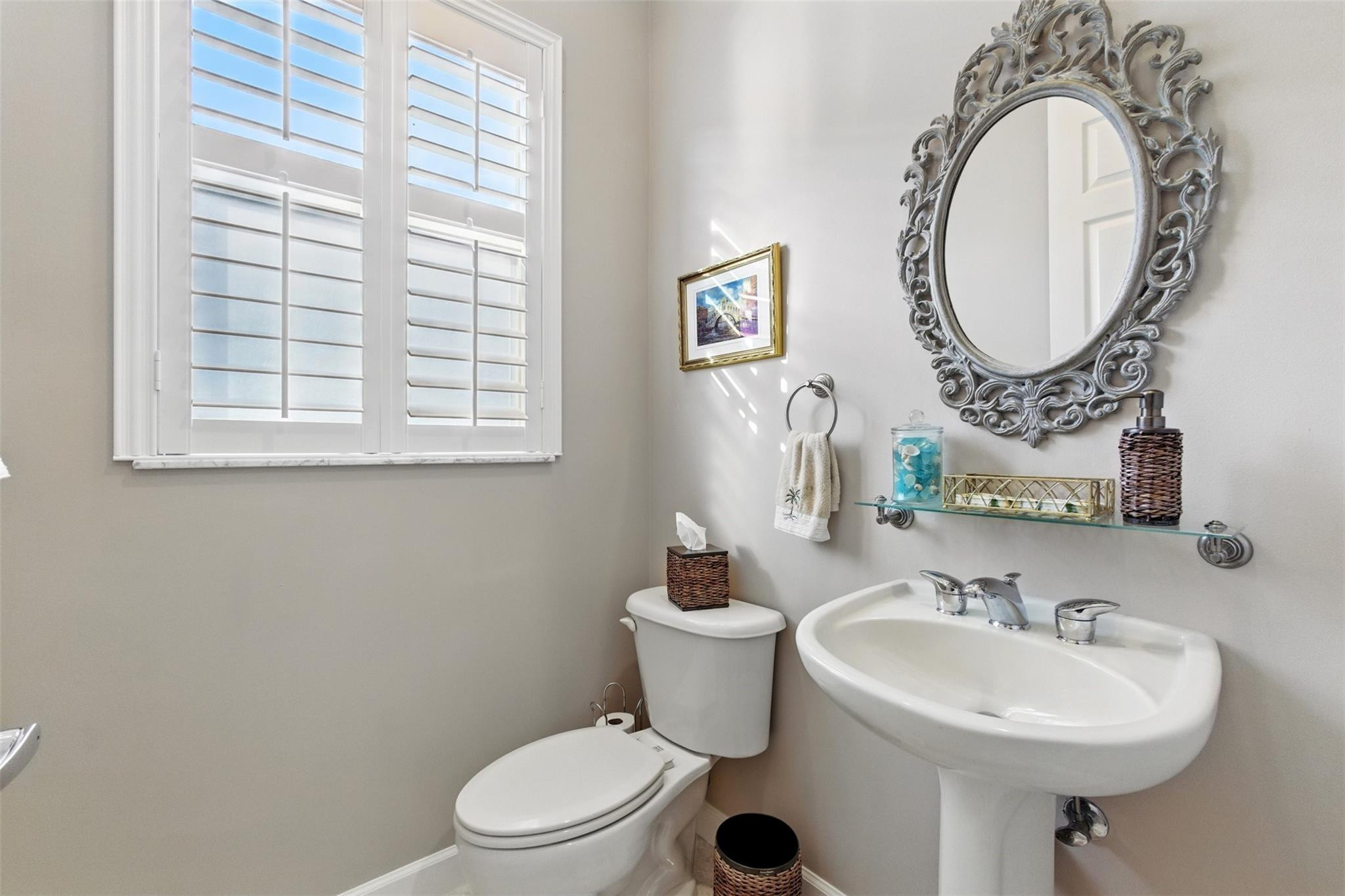 8836 First Tee Road Port St. Lucie, FL 34986 - Photo 22 of 35 a bathroom with a sink mirror toilet and a window