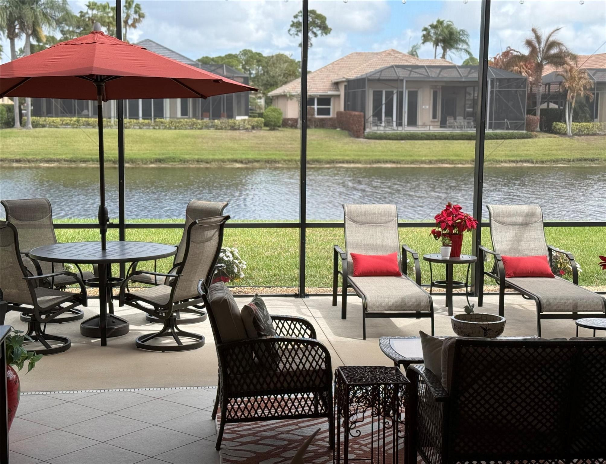 8836 First Tee Road Port St. Lucie, FL 34986 - Photo 26 of 35 a view of a patio with a table chairs and a table