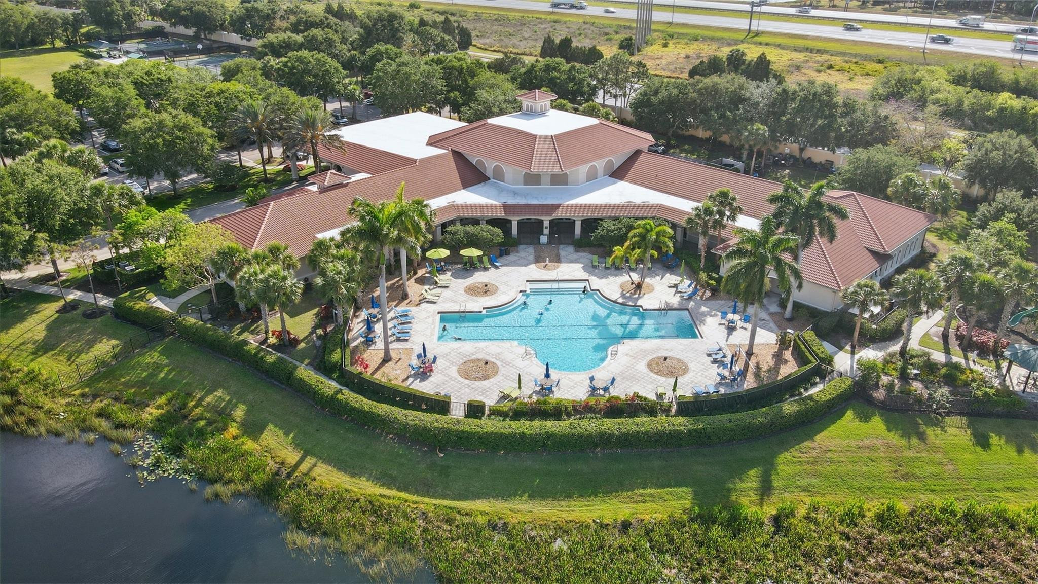 8836 First Tee Road Port St. Lucie, FL 34986 - Photo 32 of 35 a view of a swimming pool with a garden