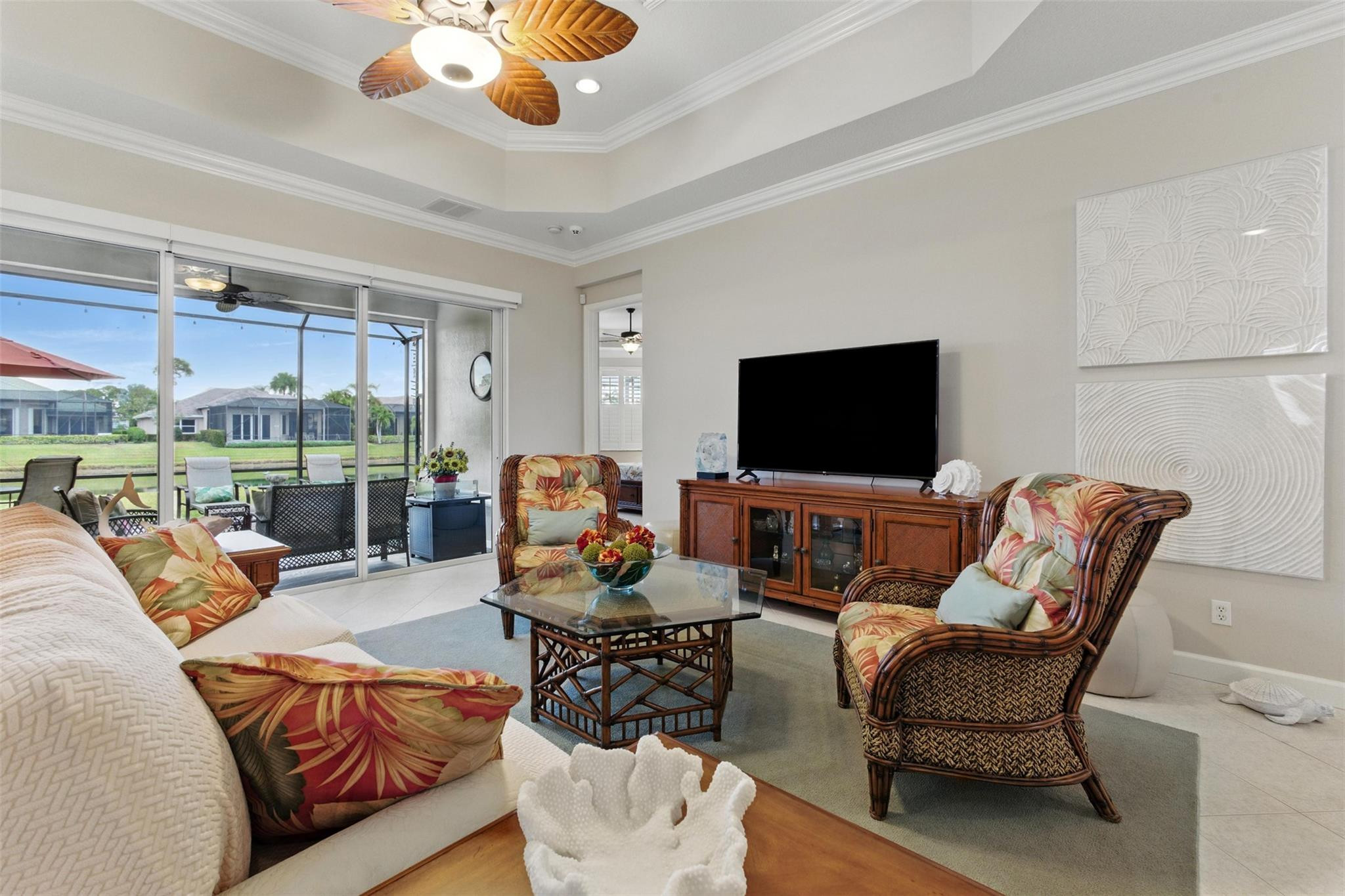 8836 First Tee Road Port St. Lucie, FL 34986 - Photo 4 of 35 a living room with furniture and a flat screen tv