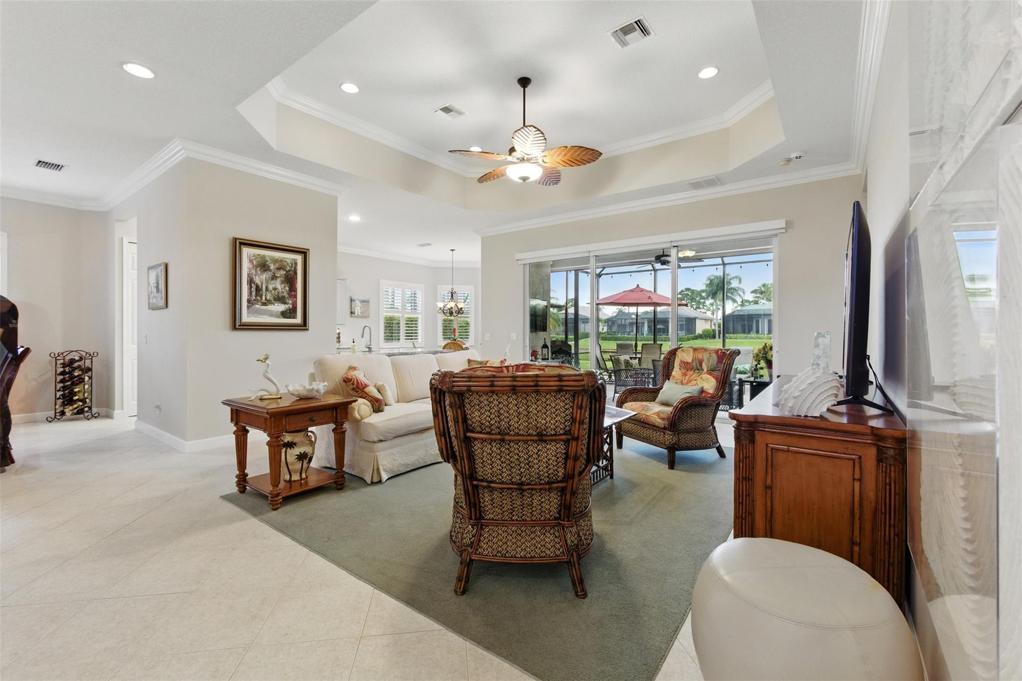 8836 First Tee Road Port St. Lucie, FL 34986 - Photo 5 of 35 a living room with furniture a chandelier and a fireplace