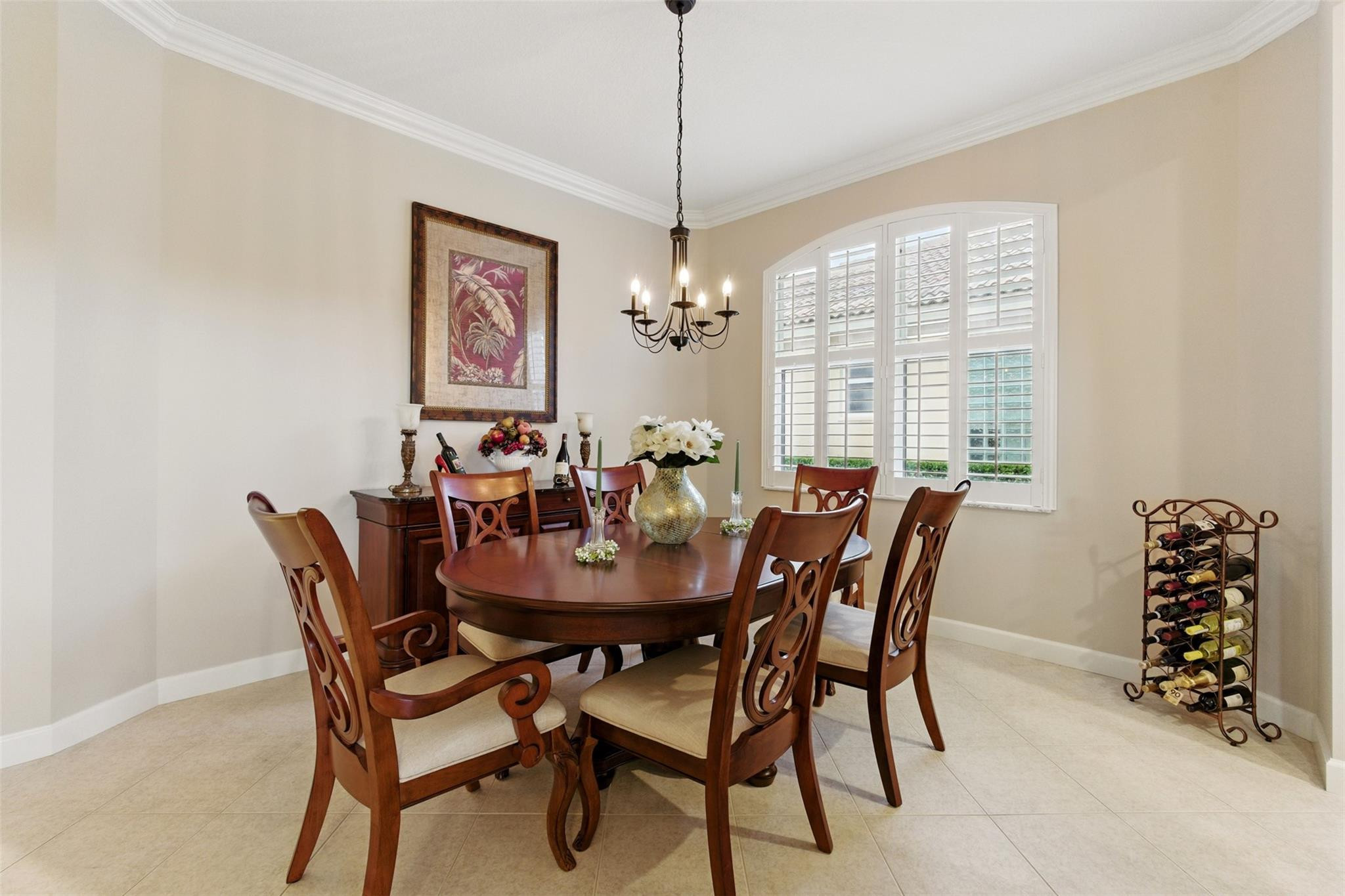 8836 First Tee Road Port St. Lucie, FL 34986 - Photo 7 of 35 a dining room with furniture a chandelier and window