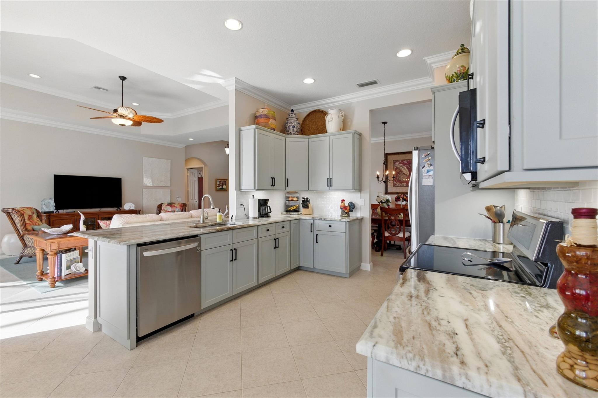8836 First Tee Road Port St. Lucie, FL 34986 - Photo 9 of 35 a kitchen that has a lot of cabinets in it and appliances