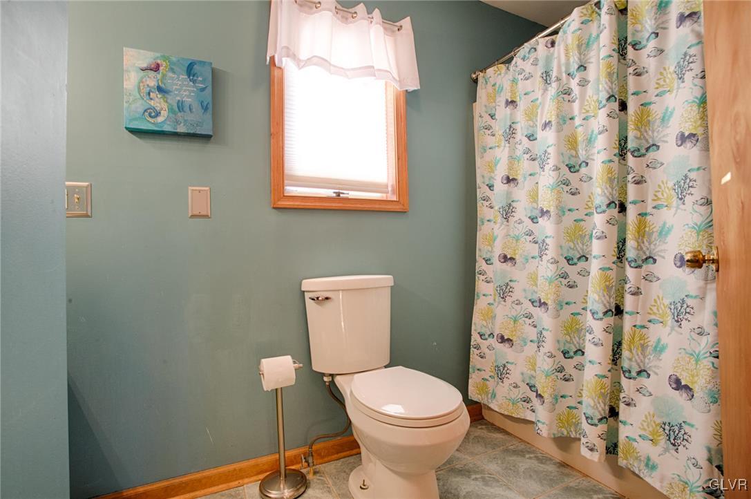 455 Bauer Road Bath, PA 18014 - Photo 13 of 26 a white toilet sitting next to a shower curtain