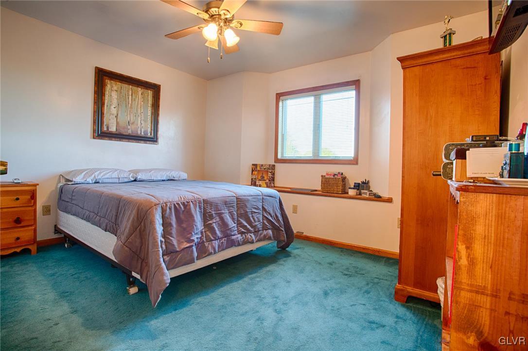 455 Bauer Road Bath, PA 18014 - Photo 14 of 26 a bedroom with a bed and a chandelier