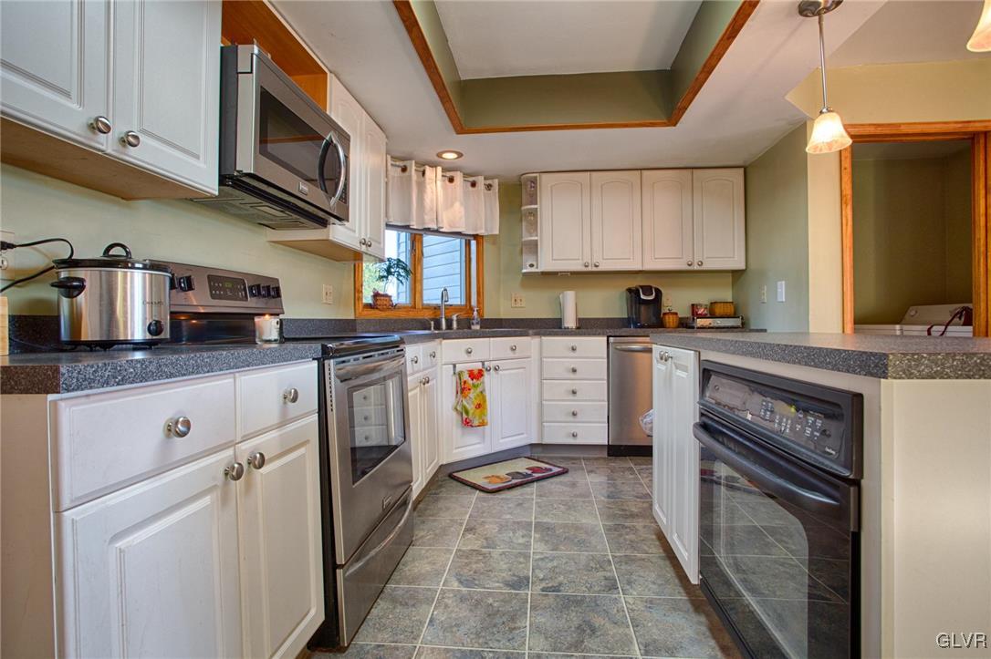 455 Bauer Road Bath, PA 18014 - Photo 3 of 26 a kitchen with stainless steel appliances granite countertop a stove a sink dishwasher and a refrigerator
