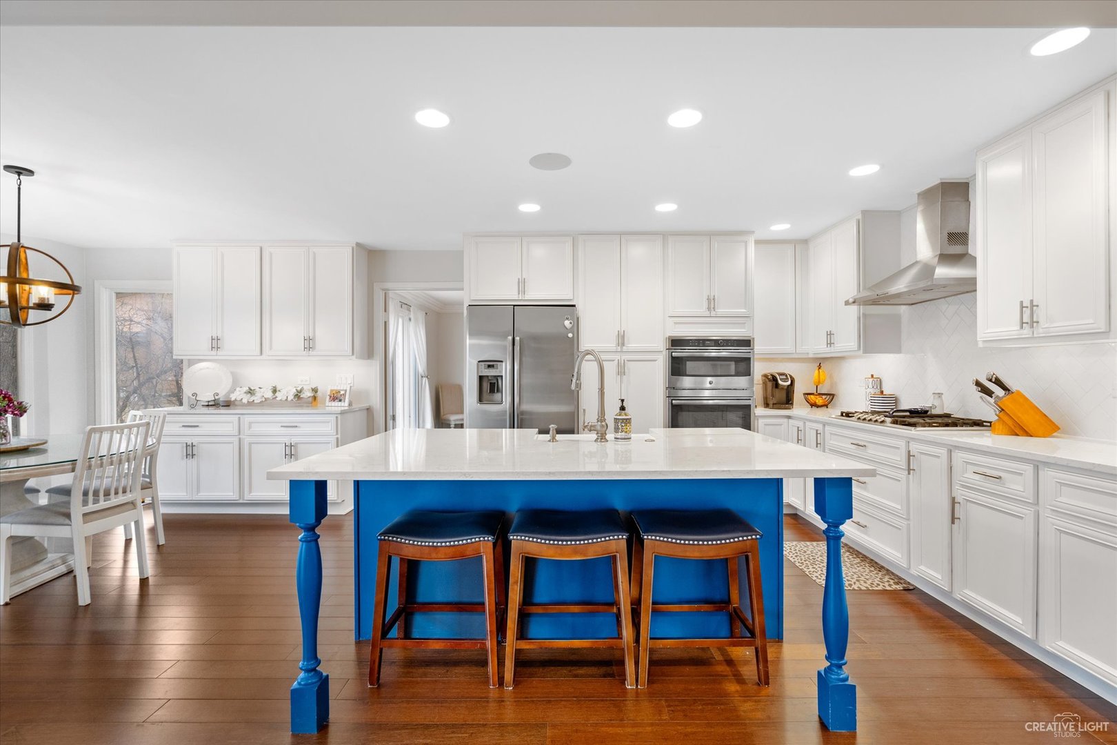 734 Forest Glen Lane Oak Brook, IL 60523 - Photo 16 of 36 a kitchen with stainless steel appliances wooden floor and white refrigerator
