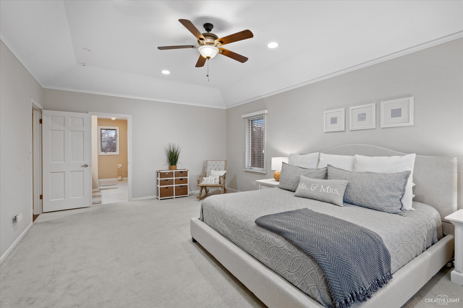 734 Forest Glen Lane Oak Brook, IL 60523 - Photo 29 of 36 a spacious bedroom with a bed a couch and a chandelier