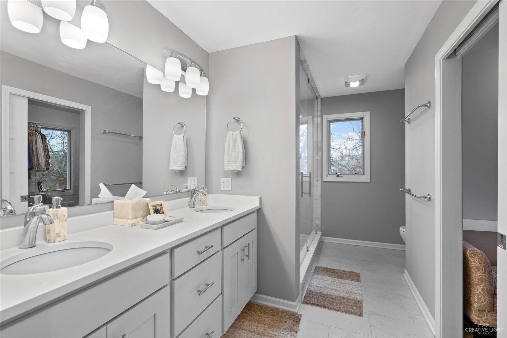 734 Forest Glen Lane Oak Brook, IL 60523 - Photo 30 of 36 a bathroom with a double vanity sink and a mirror