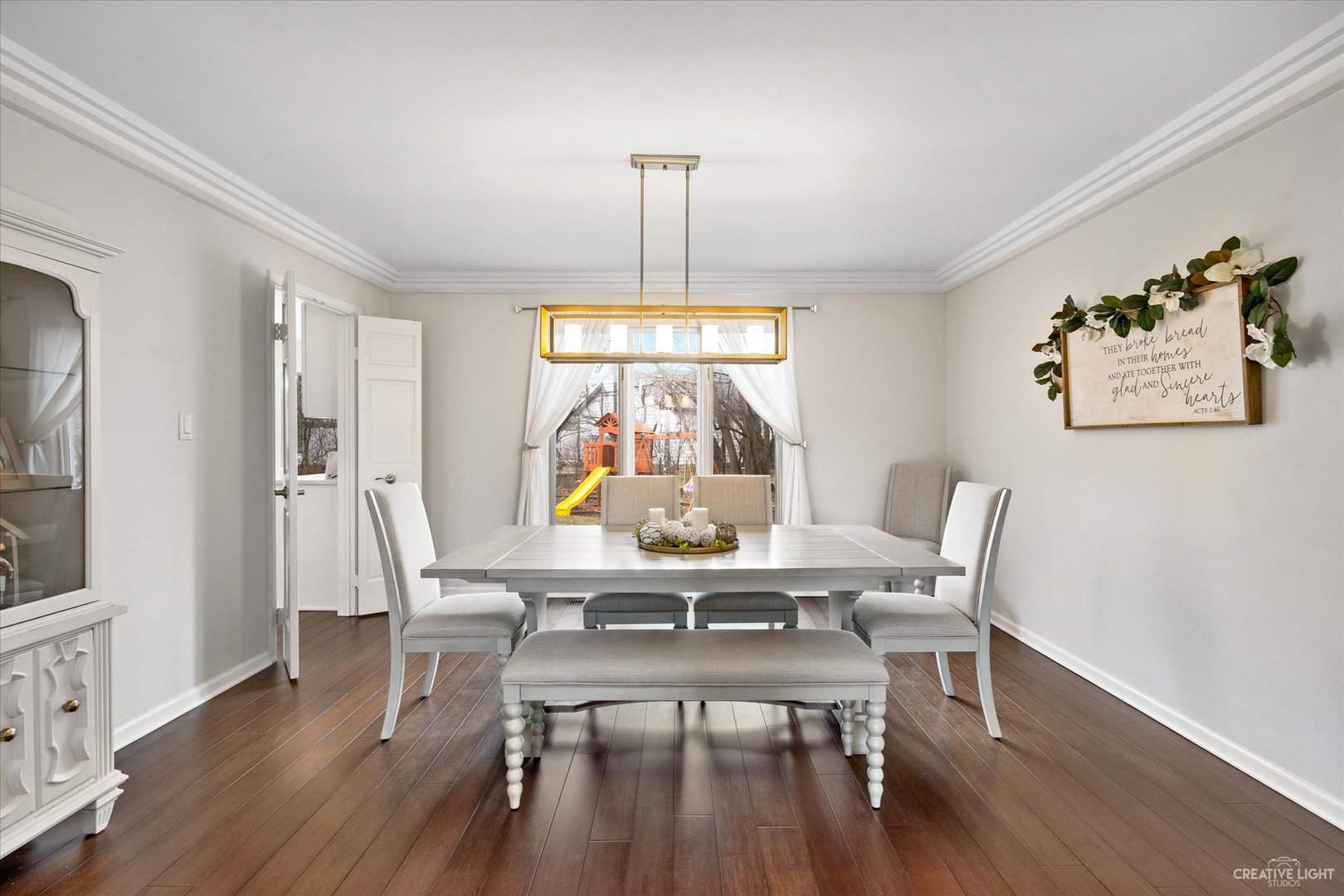 734 Forest Glen Lane Oak Brook, IL 60523 - Photo 7 of 36 a dining room with furniture a chandelier and wooden floor