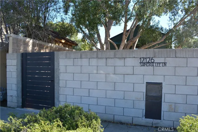 a view of a house with a tree in front of it