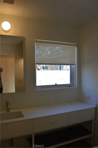 a wooden bench sitting in the middle of a yard