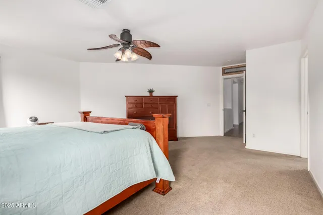 a bedroom with a bed and cabinets