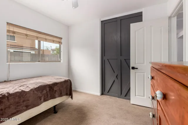 a bedroom with a bed and a window