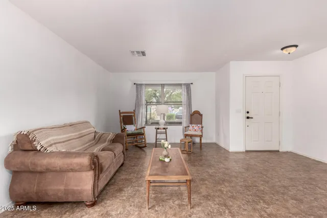 a living room with furniture a window and a table