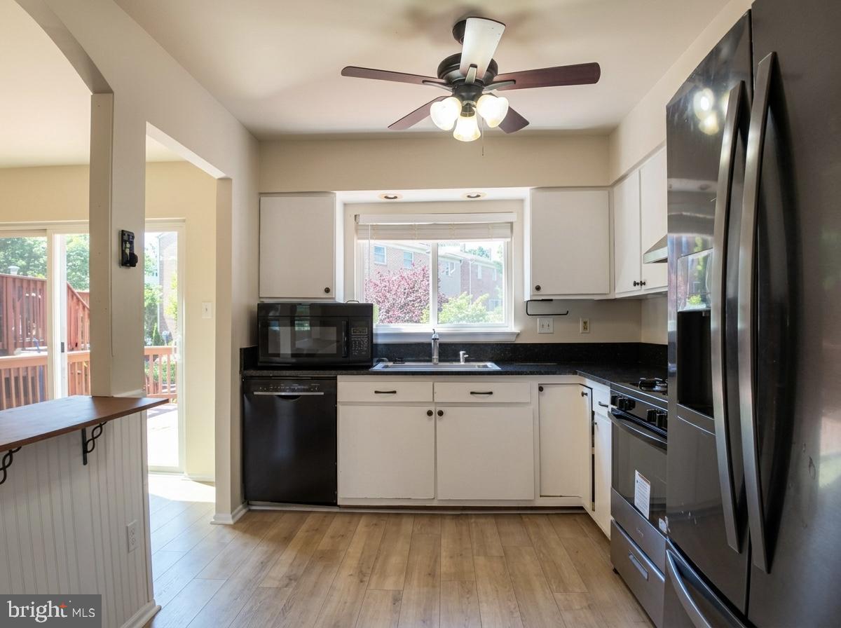 3614 Fawn Spring Court Baltimore, MD 21234 - Photo 7 of 22 a kitchen with stainless steel appliances granite countertop a refrigerator a stove a sink and a microwave
