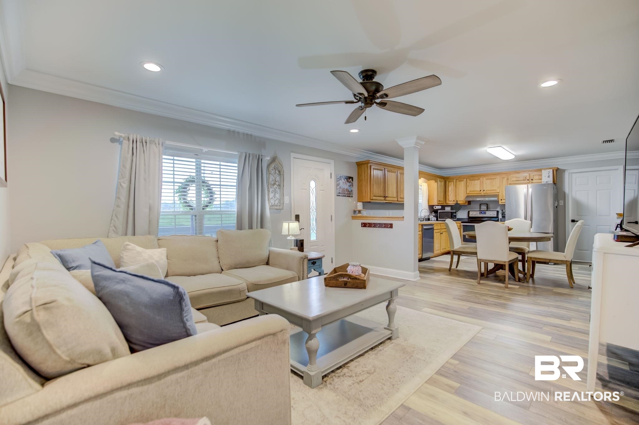 18732 Fairground Road Robertsdale, AL 36567 - Photo 9 of 46 Living room featuring ornamental molding, light hardwood / wood-style flooring, and ceiling fan