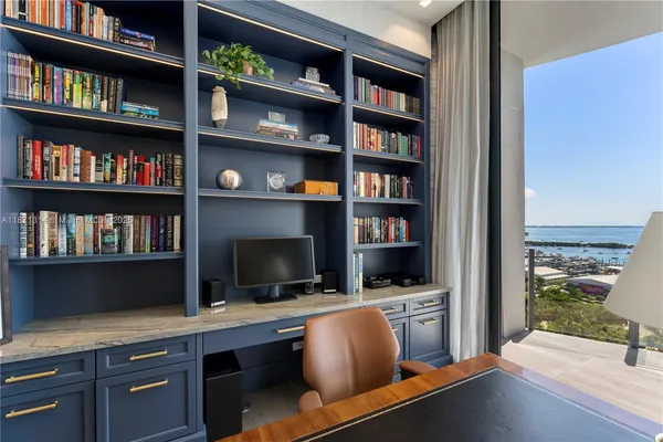 a view of a workspace with bookshelf