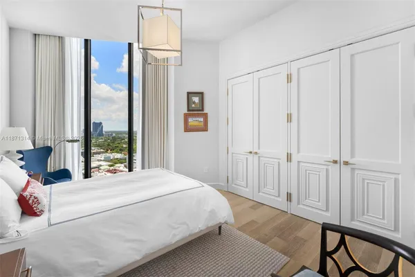 a bedroom with a large bed and a window