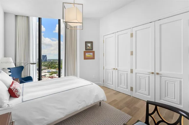 a bedroom with a large bed and a window