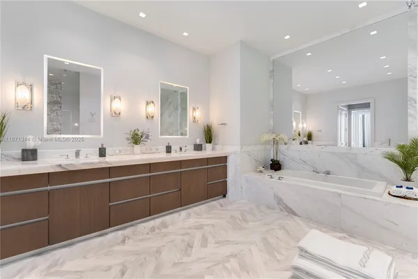 a large bathroom with a large tub sink and mirror