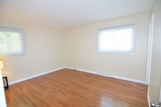 716 Lisa Road West Dundee, IL 60118 - Photo 7 of 18 an empty room with wooden floor and windows