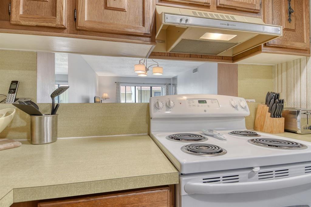 6157 Midnight Pass Road, Unit E63 Sarasota, FL 34242 - Photo 21 of 61 a stove top oven sitting inside of a kitchen