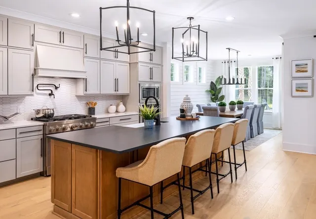 a kitchen with stainless steel appliances kitchen island granite countertop a sink and cabinets