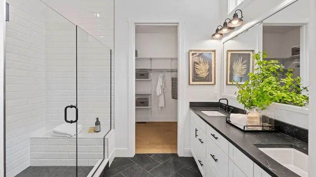 a bathroom with a granite countertop sink a toilet and shower