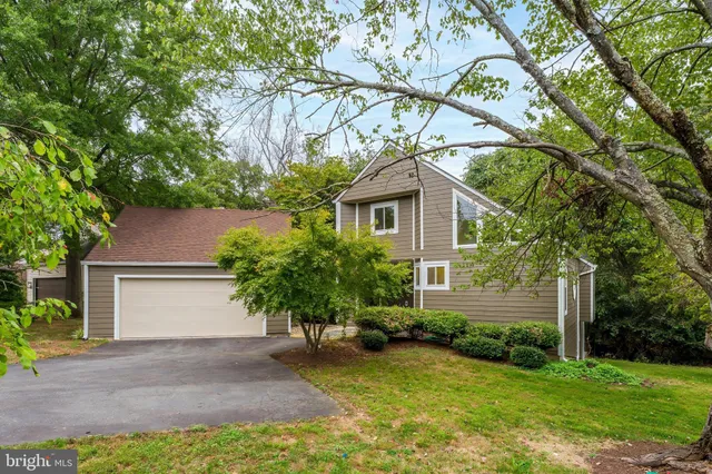 a house that has a tree in front of it